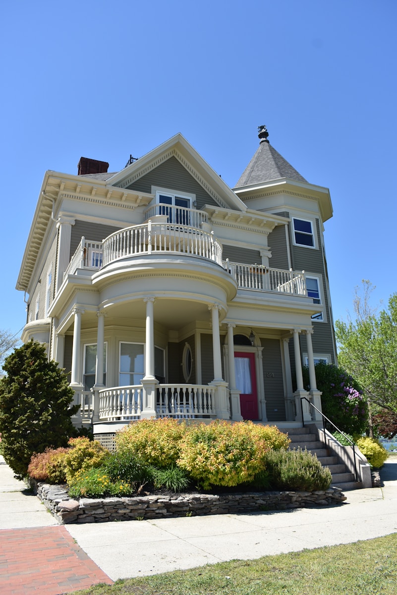 white and gray wooden 2-storey houseprotected by homeowners insurance