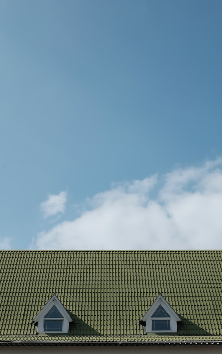 green wooden house roof with roof coverage